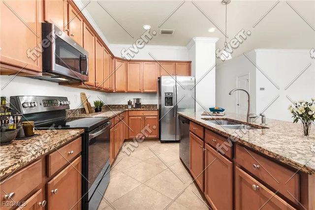 a kitchen with stainless steel appliances granite countertop a sink a stove and a refrigerator
