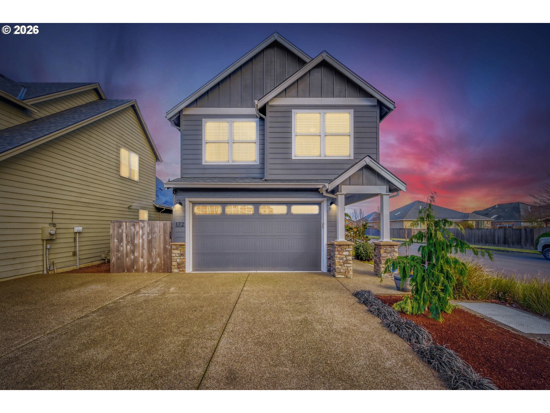 a front view of a house with a yard and garage