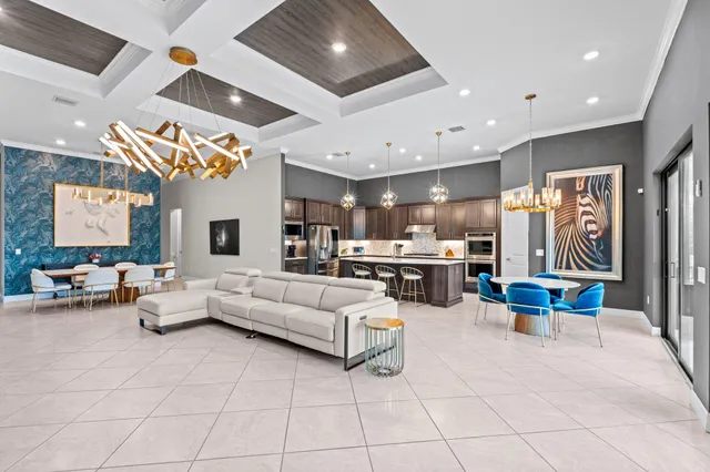 a living room with furniture and kitchen view