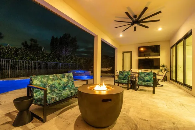 a view of a couches and dinning table in patio