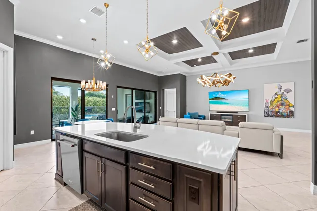 a dining hall with stainless steel appliances granite countertop a sink and a refrigerator