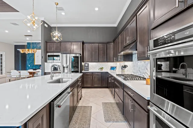 a kitchen with stainless steel appliances granite countertop a sink stove and refrigerator