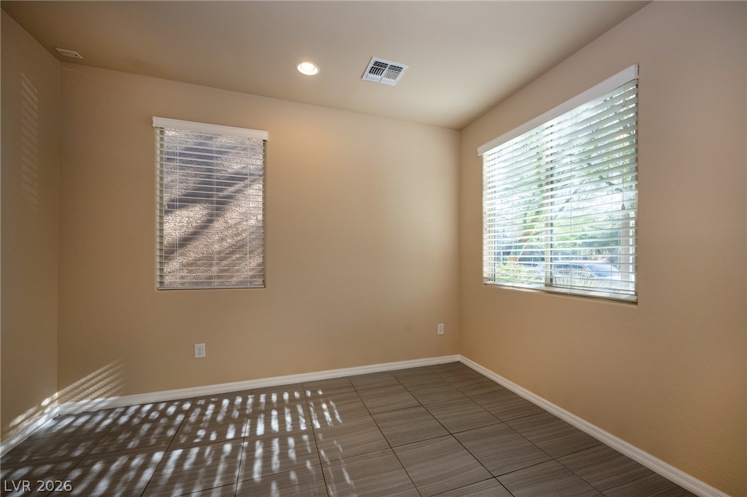 11016 Prairie Grove Road Las Vegas, NV 89179 - Photo 5 of 37 Naturally illuminated interiors create an inviting atmosphere, complemented by elegant tiled flooring and recessed lighting.