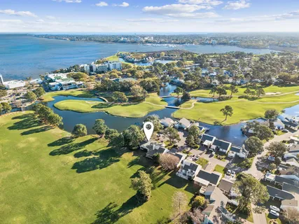 a living room with furniture a table and wooden floor