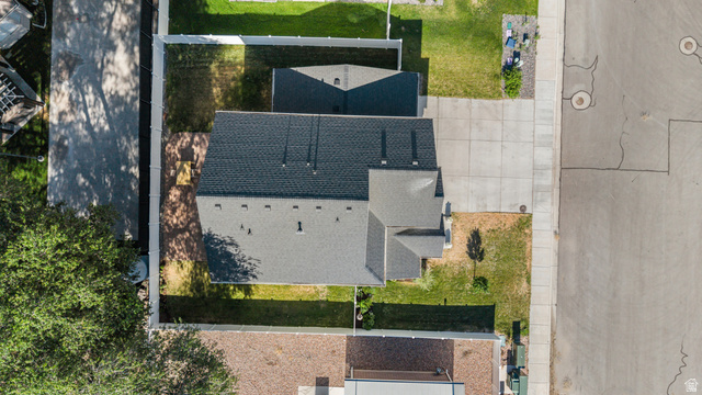 2706 West Maple Street, Unit 285 Mapleton, UT 84664 - Photo 33 of 36 Residential property featuring a dark shingle roof, concrete driveway, fenced perimeter, and a detached structure