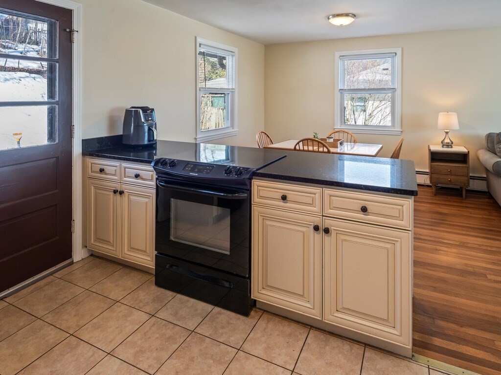248 St Nicholas Avenue Worcester, MA 01606 - Photo 11 of 30 a kitchen with granite countertop a stove top oven and cabinets