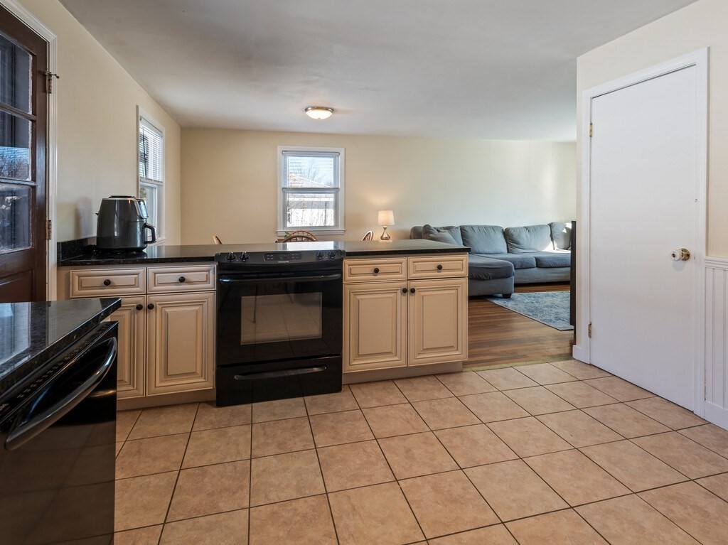 248 St Nicholas Avenue Worcester, MA 01606 - Photo 12 of 30 a kitchen with stainless steel appliances a stove top oven and cabinets