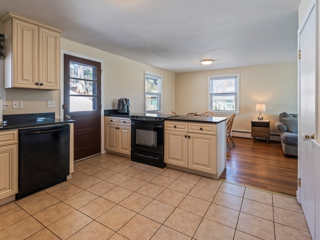 248 St Nicholas Avenue Worcester, MA 01606 - Photo 13 of 30 a kitchen with stainless steel appliances granite countertop a stove sink and cabinets