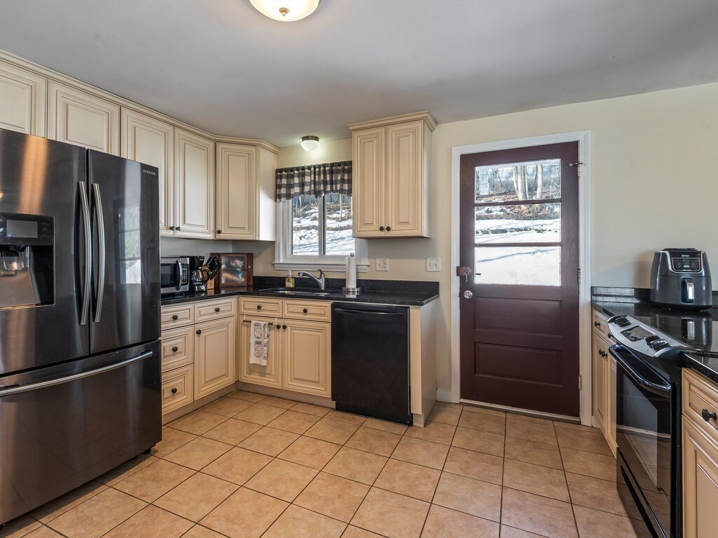 248 St Nicholas Avenue Worcester, MA 01606 - Photo 14 of 30 a kitchen with a refrigerator stove and sink