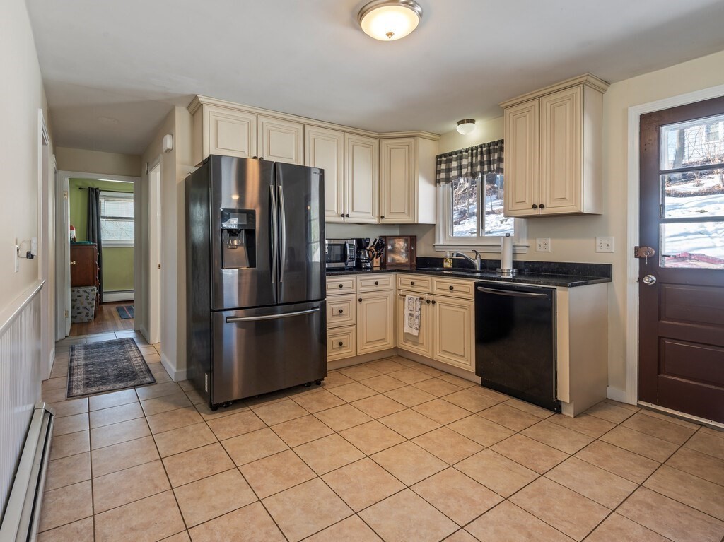 248 St Nicholas Avenue Worcester, MA 01606 - Photo 15 of 30 a kitchen with stainless steel appliances granite countertop a refrigerator sink and cabinets