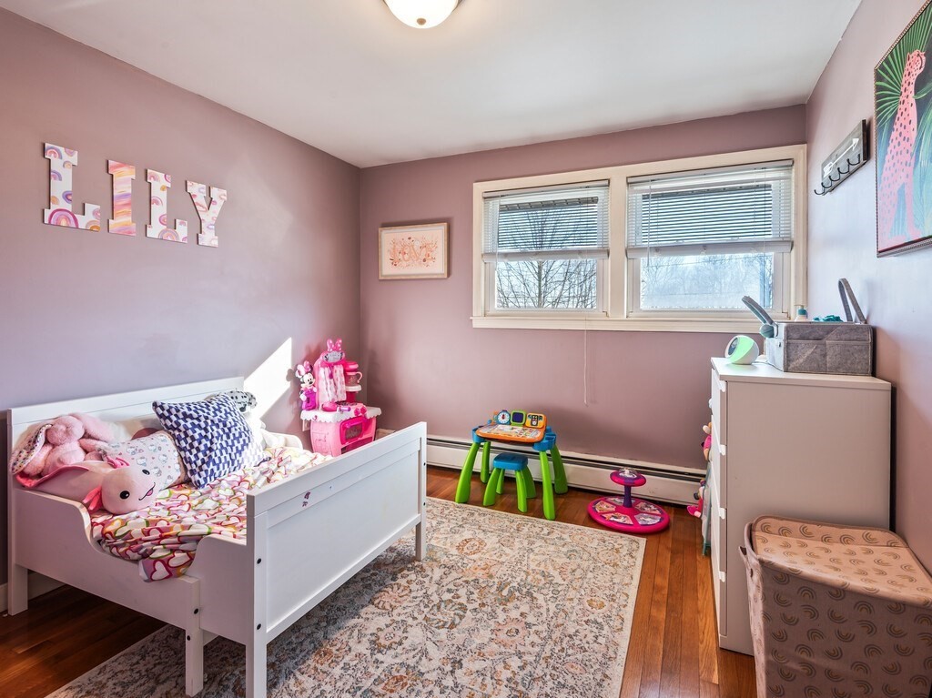 248 St Nicholas Avenue Worcester, MA 01606 - Photo 22 of 30 a bedroom with furniture and a wooden floor