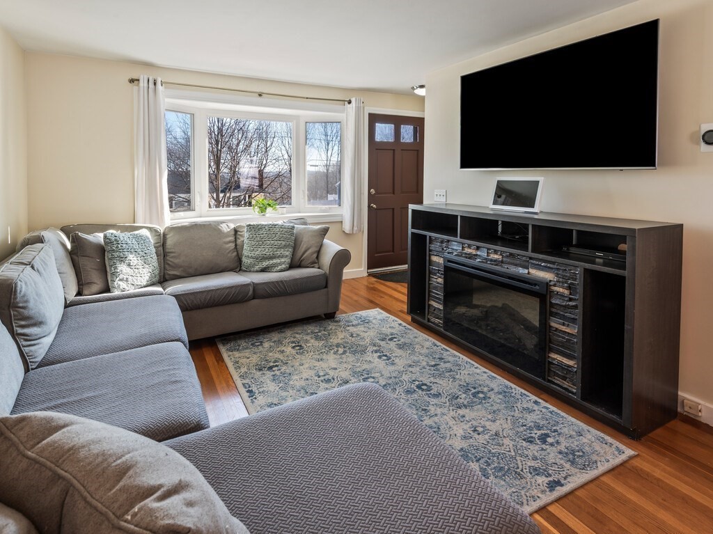 248 St Nicholas Avenue Worcester, MA 01606 - Photo 3 of 30 a living room with a flat screen tv and a fireplace