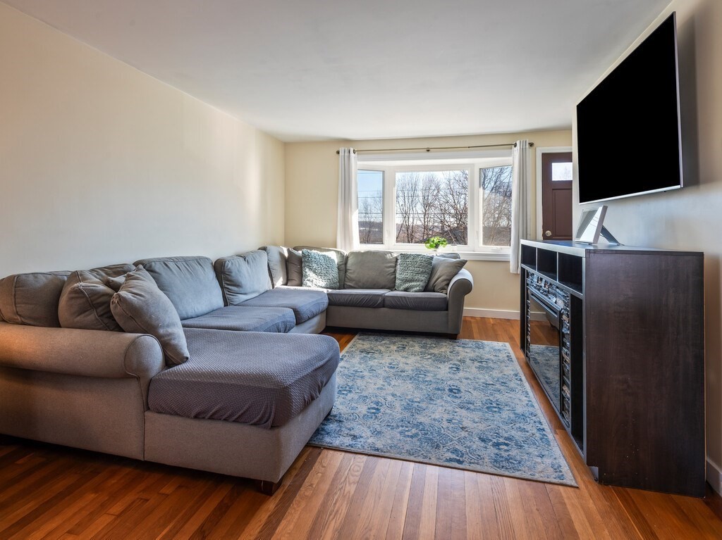 248 St Nicholas Avenue Worcester, MA 01606 - Photo 4 of 30 a living room with furniture and a flat screen tv
