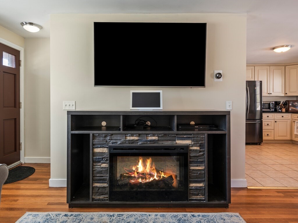 248 St Nicholas Avenue Worcester, MA 01606 - Photo 6 of 30 a living room with a fireplace and a flat screen tv