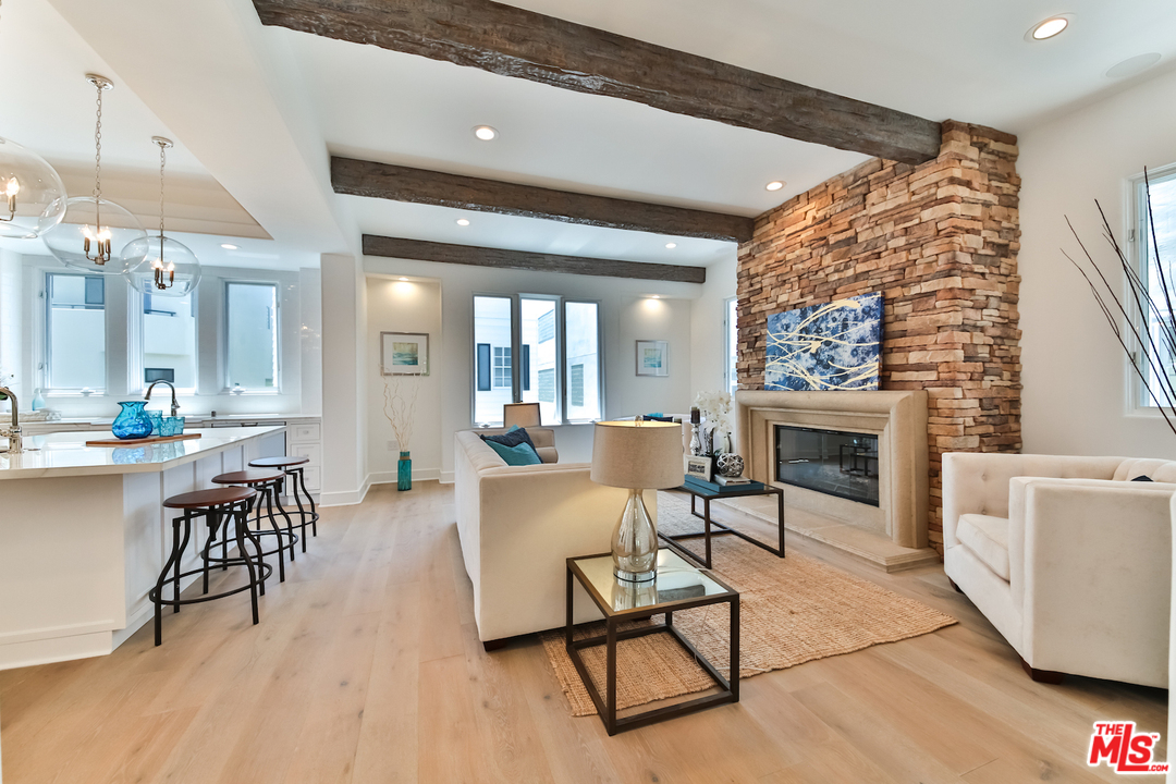 124 Reef Mall Marina del Rey, CA 90292 - Photo 14 of 44 a living room with furniture a fireplace and a table