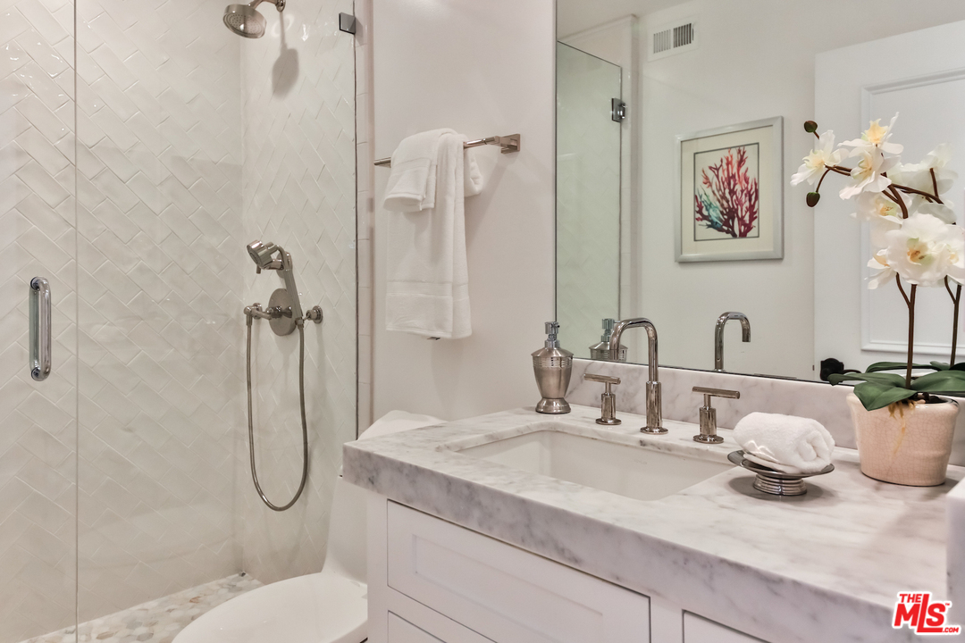 124 Reef Mall Marina del Rey, CA 90292 - Photo 17 of 44 a bathroom with a granite countertop sink toilet and shower