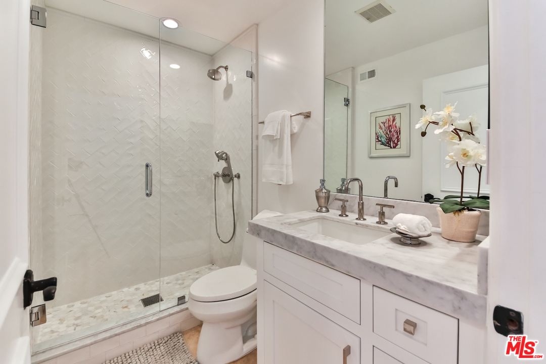 124 Reef Mall Marina del Rey, CA 90292 - Photo 18 of 44 a bathroom with a granite countertop sink a toilet and shower