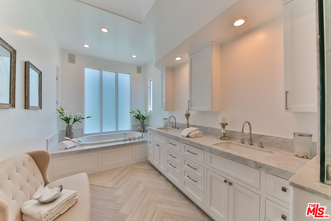 124 Reef Mall Marina del Rey, CA 90292 - Photo 29 of 44 a spacious bathroom with a granite countertop tub a double vanity sink and a mirror