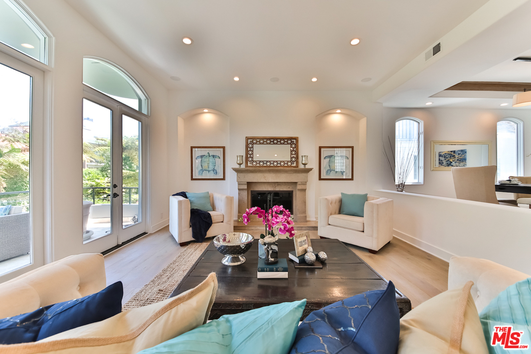 124 Reef Mall Marina del Rey, CA 90292 - Photo 5 of 44 a living room with fireplace furniture and a large window