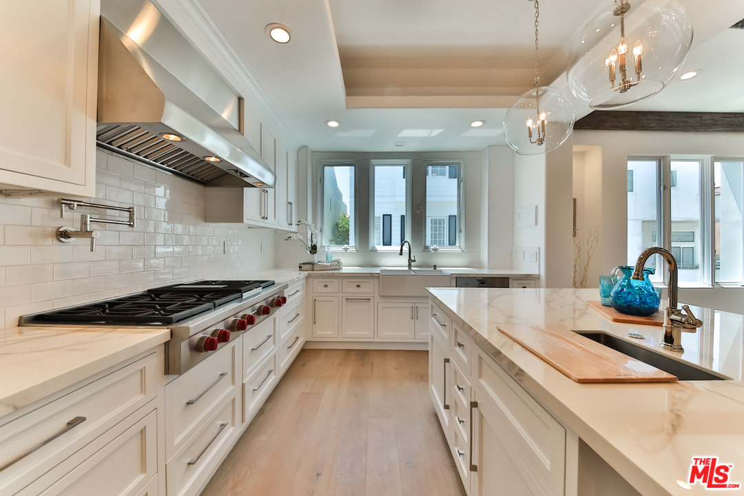 124 Reef Mall Marina del Rey, CA 90292 - Photo 8 of 44 a kitchen with stainless steel appliances granite countertop a sink and a stove