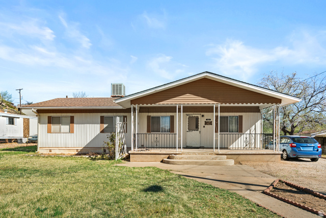49 600 North Hurricane, UT 84737 - Photo 1 of 33 View of front of property featuring a porch, a shingled roof, and a front yard