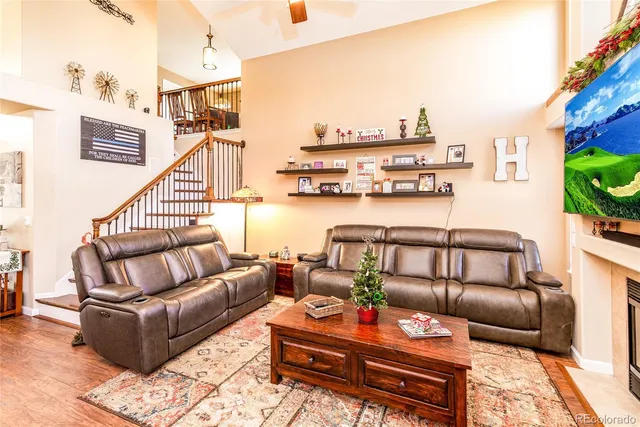 a rooftop view with patio couches coffee table and potted plants with sky view
