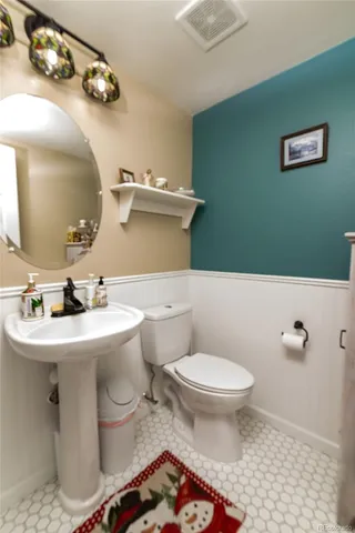 a bathroom with a sink toilet and mirror