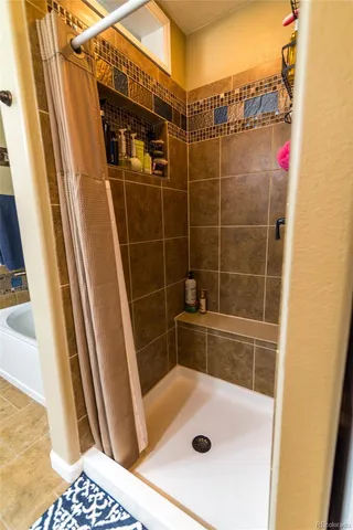 a bathroom with a tub and a shower