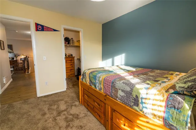 a bedroom with a bed and a painting on the wall