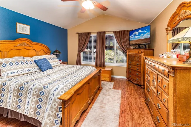 a spacious bedroom with a large bed and a flat screen tv