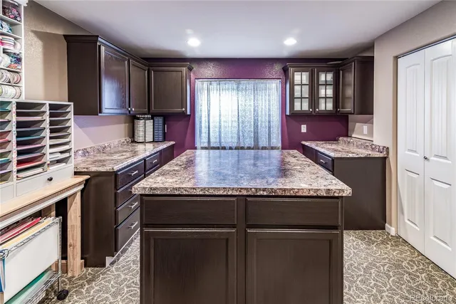 a kitchen with granite countertop stainless steel appliances and wooden cabinets
