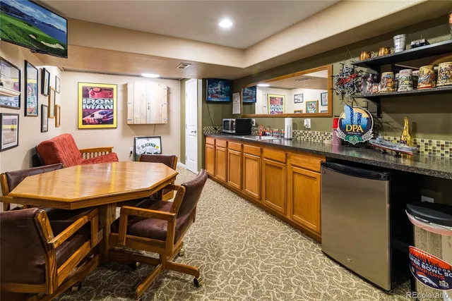 a kitchen with stainless steel appliances granite countertop a sink and a refrigerator