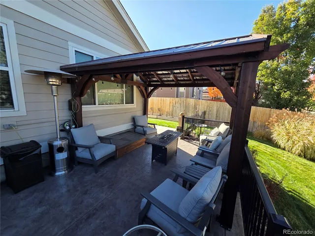 a sitting area with furniture and wooden deck
