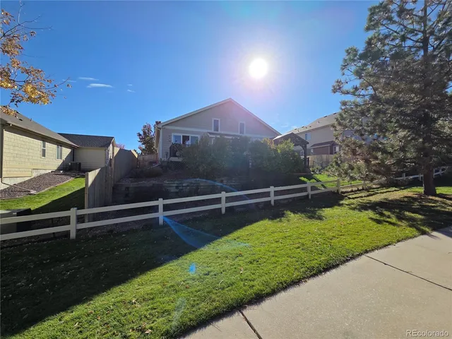 a view of a garden with a bench in the background