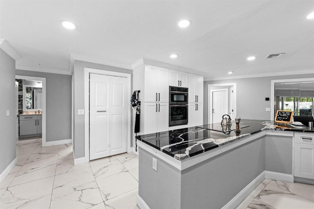 2850 Landover Drive Clearwater, FL 33761 - Photo 13 of 33 a kitchen that has a sink and a stove in it