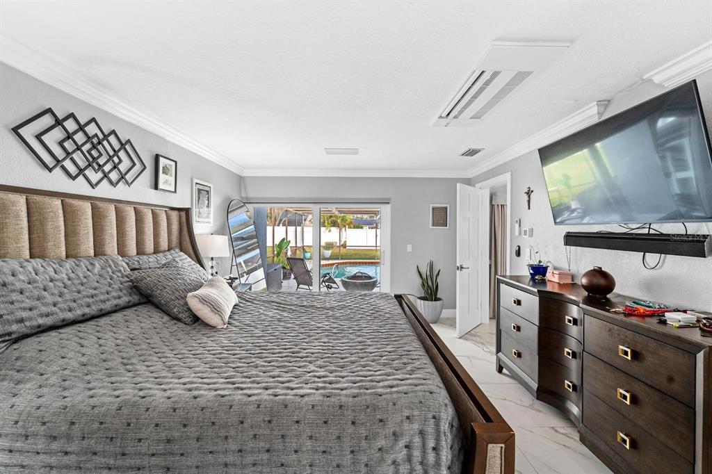 2850 Landover Drive Clearwater, FL 33761 - Photo 15 of 33 a bedroom with a bed a couch and large windows