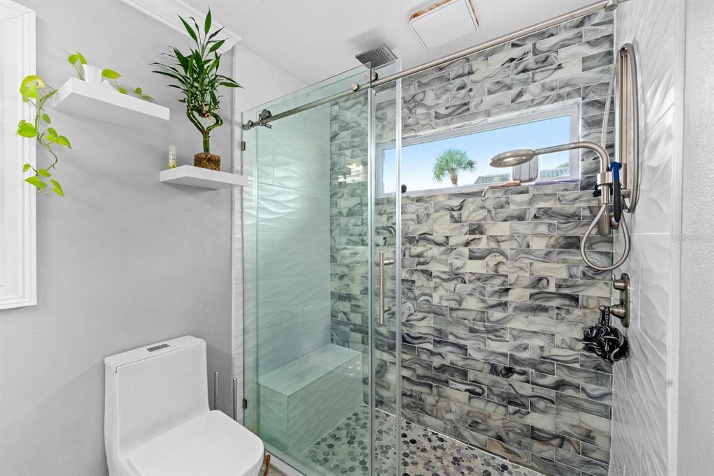 2850 Landover Drive Clearwater, FL 33761 - Photo 18 of 33 a bathroom with a shower a toilet and a shower curtain