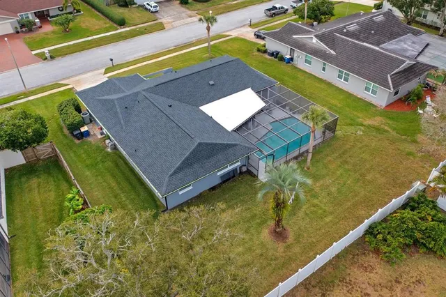 an aerial view of a residential apartment building with a yard