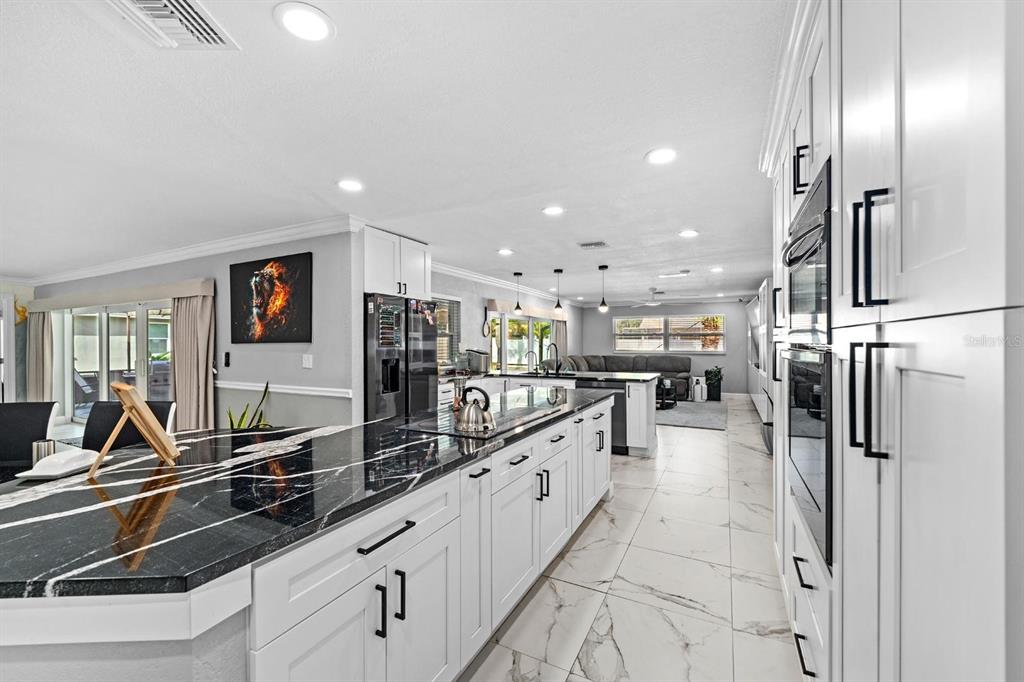 2850 Landover Drive Clearwater, FL 33761 - Photo 10 of 33 a large white kitchen with lots of counter top space a sink and stainless steel appliances