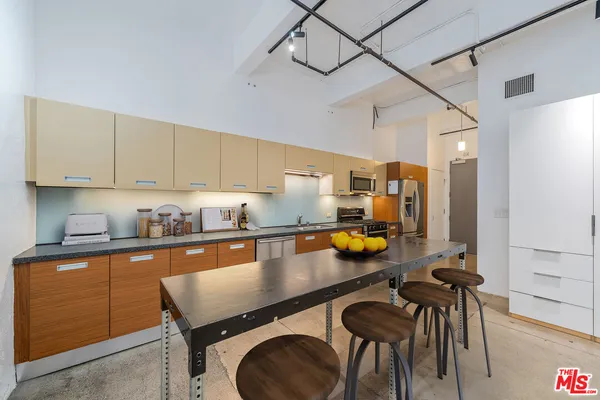 a kitchen with a table chairs stove and cabinets