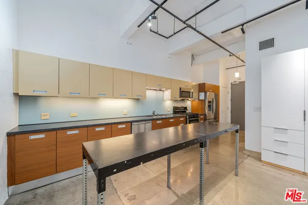 a kitchen with stainless steel appliances granite countertop a sink counter space and cabinets