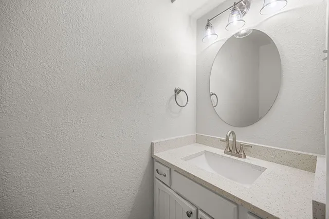 a bathroom with a sink and mirror