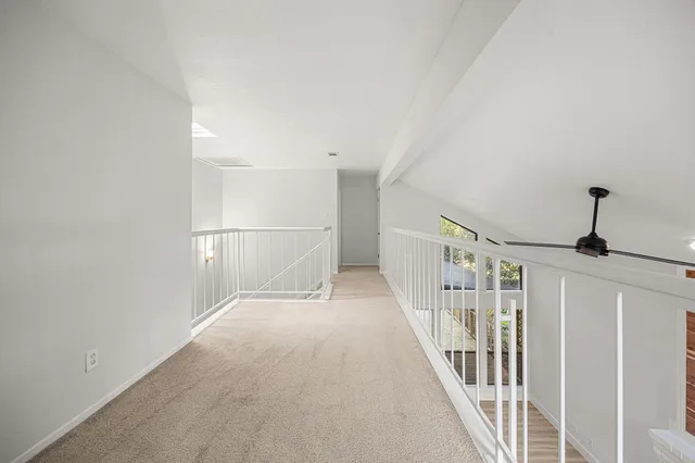 a view of a hallway with staircase