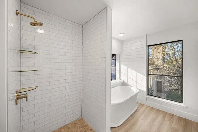 a bathroom with a tub and a shower