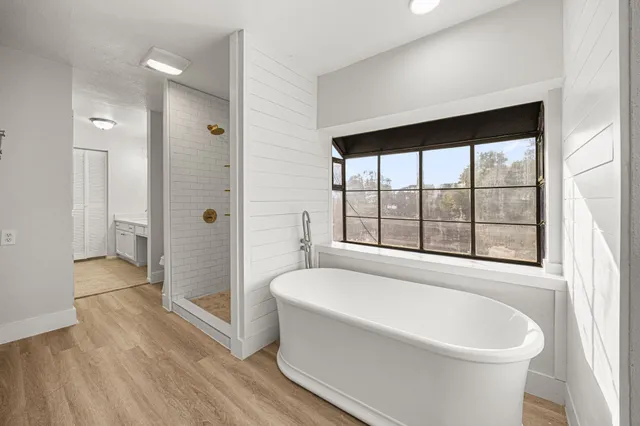 a bathroom with a bathtub and a shower