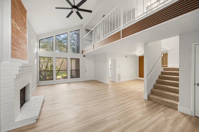 a view of an entryway with wooden floor and a fireplace