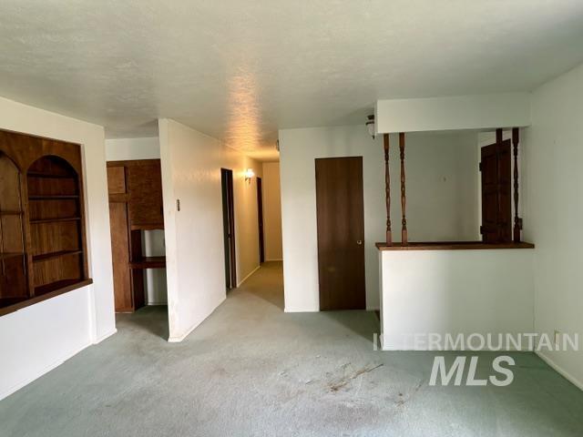 555 Cemetery Road Cambridge, ID 83610 - Photo 2 of 41 Built-in shelving unit, interior wood-paneling, and wood-finish doors