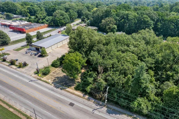 an aerial view of a house with a yard and street
