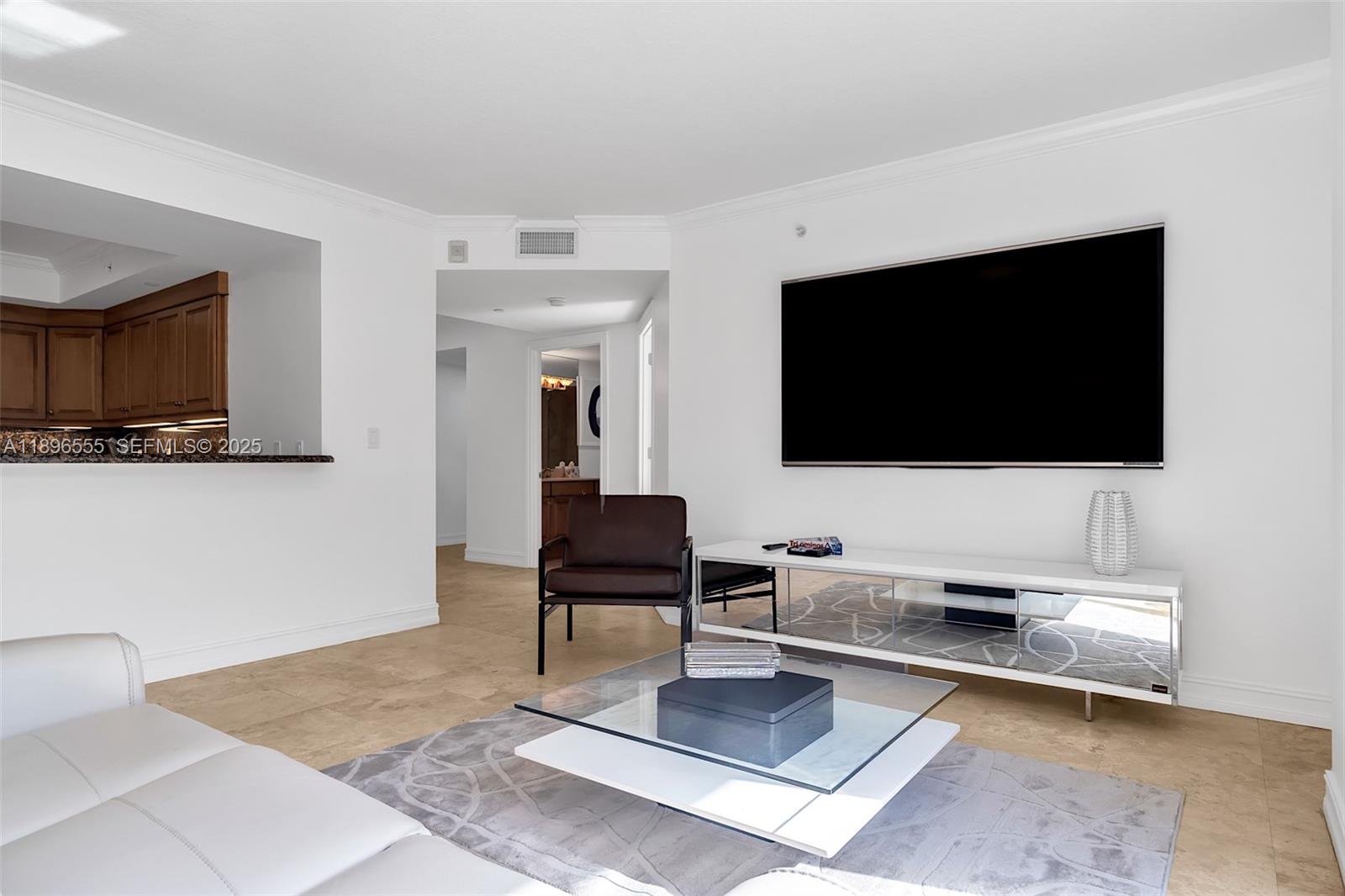 9 Northeast 20th Avenue, Unit 302 Deerfield Beach, FL 33441 - Photo 11 of 55 a living room with furniture and a flat screen tv