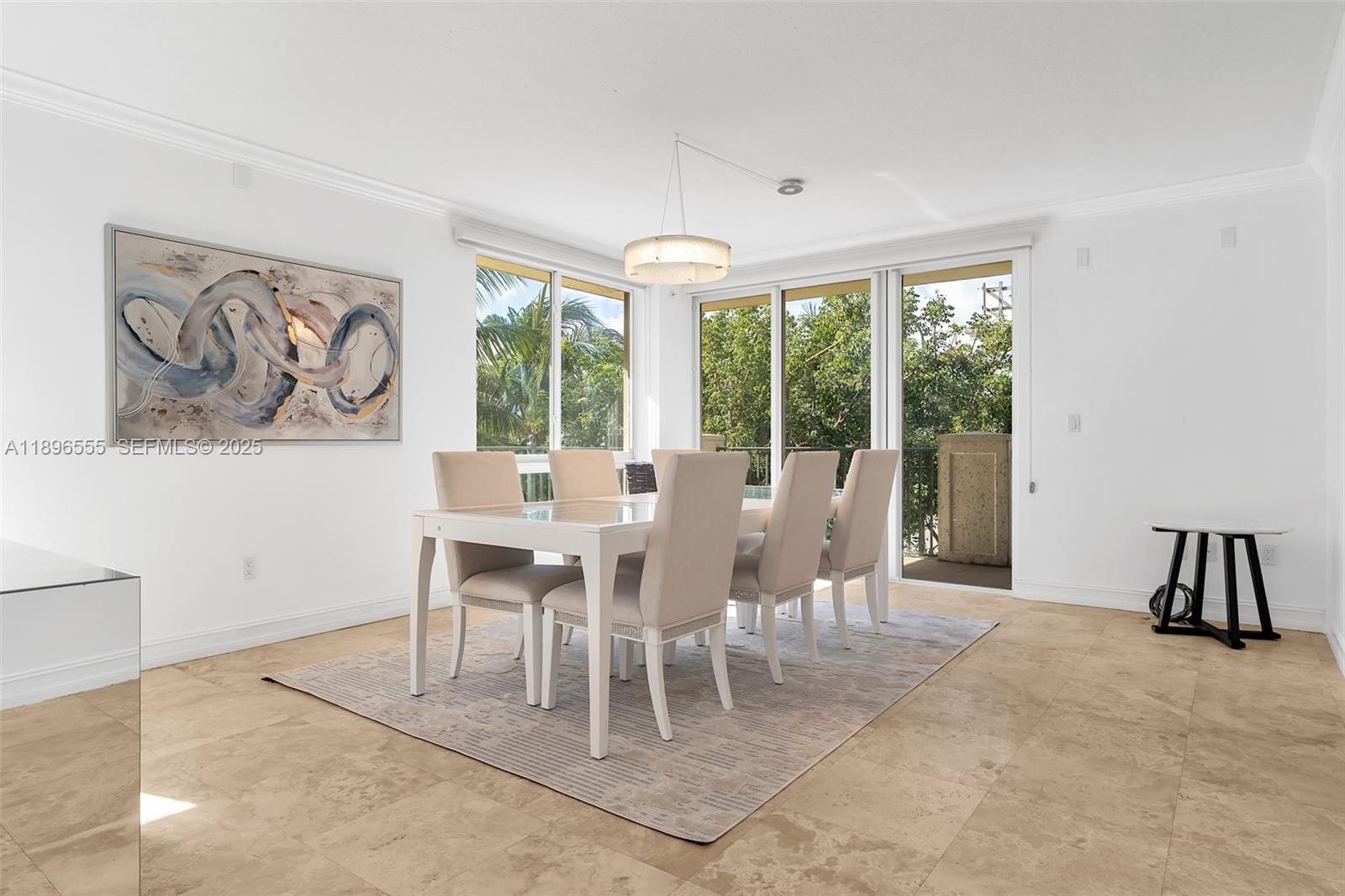 9 Northeast 20th Avenue, Unit 302 Deerfield Beach, FL 33441 - Photo 14 of 55 a dining room with furniture a chandelier and a rug
